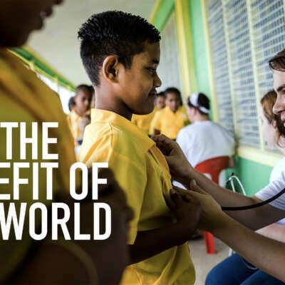young adult male using a stethoscope on a young child